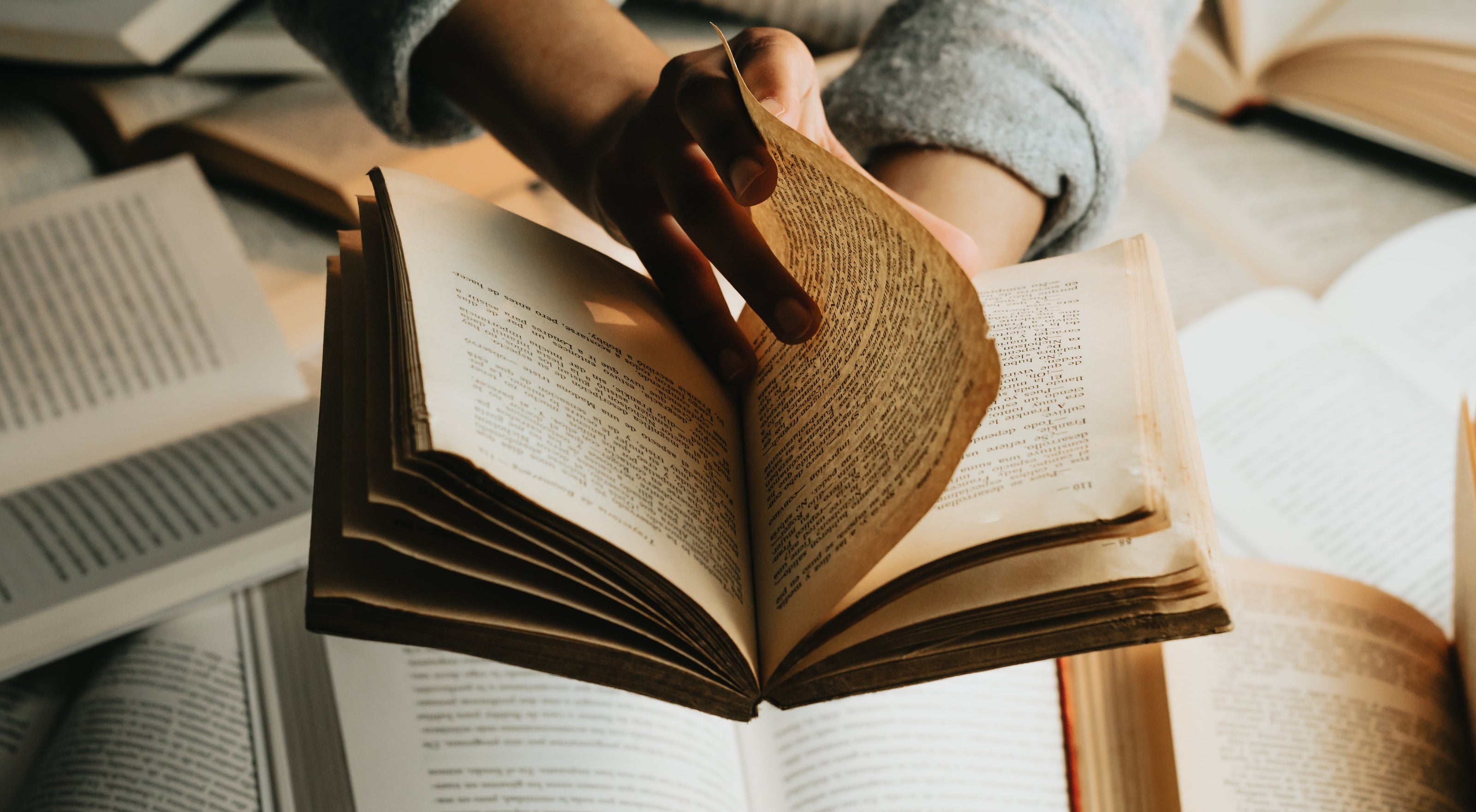 Researcher using open books on desk